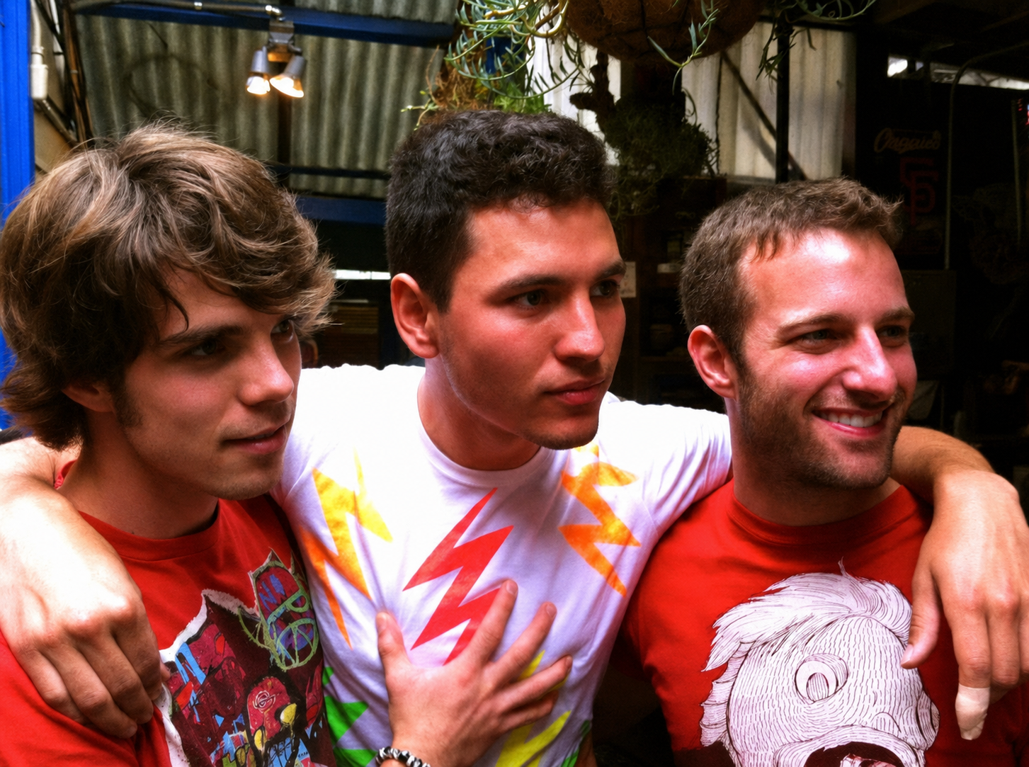 Faust Whale standing with Alby and Elliott, their arms around one another